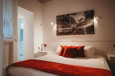 a bedroom with a bed with a painting on the wall at Hani Chrysomilou in Kalopanayiotis