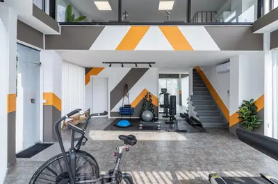 a house with a bike in the middle of a gym at Local Host Living - Signature Apartments in Nicosia in Nicosia