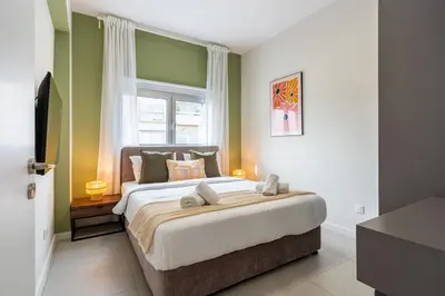a bedroom with a large bed with a window at Local Host Living - Signature Apartments in Nicosia in Nicosia