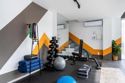 a room with a gym with a striped wall at Local Host Living - Signature Apartments in Nicosia in Nicosia