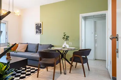 a living room with a couch and a table at Local Host Living - Signature Apartments in Nicosia in Nicosia