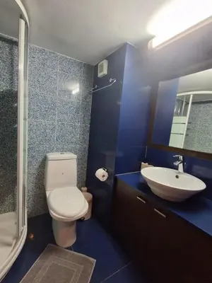 a blue bathroom with a toilet and a sink at Lazuli Sea View Beachfront Studio Nr 305 in Larnaka