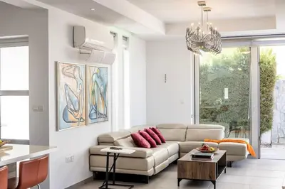 a living room with a couch and a table at Milos lifestyle H29 in Protaras