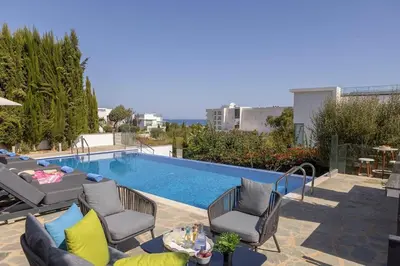 a patio with chairs and a swimming pool at Milos lifestyle H29 in Protaras