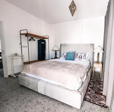 a bedroom with a bed and two tables and two lamps at Nicosia city center 1BDR apartment in Nicosia