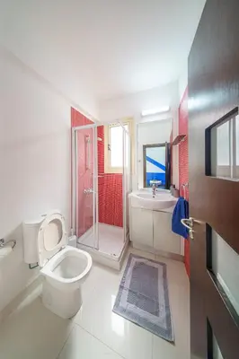 a bathroom with a toilet and a shower and a sink at Villa Waves in Mazotos