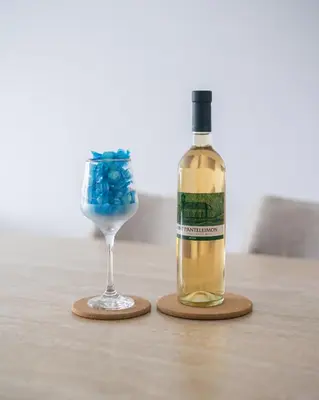 a bottle of wine and a glass on a table at Maestro Family - Apartment in Larnaka