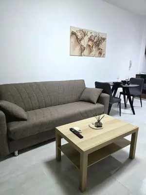 a living room with a couch and a coffee table at 5mins from the beach,10mins from LC airport Aurelia Suite in Larnaka