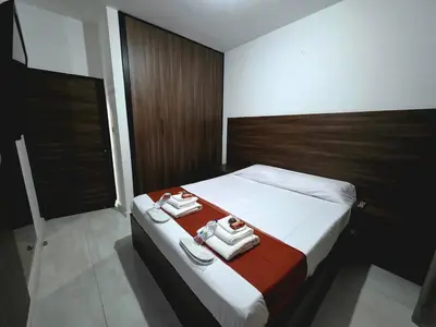 a bedroom with a bed with two towels on it at 5mins from the beach,10mins from LC airport Aurelia Suite in Larnaka