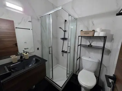 a bathroom with a shower and a toilet and a sink at 5mins from the beach,10mins from LC airport Aurelia Suite in Larnaka
