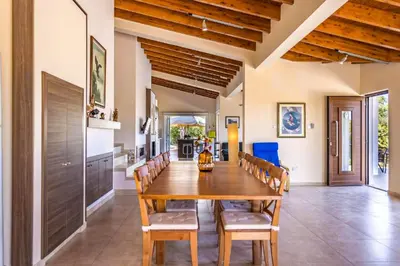 a dining room with a wooden table and chairs at Marina Heights Villa in Protaras