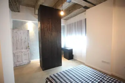 a bedroom with a bed with a checkered blanket at G.R City Heart in Nicosia