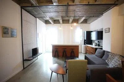 a living room with a couch and a tv at G.R City Heart in Nicosia