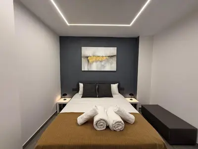 a bedroom with a bed with towels on it at Onar Exclusive Studio Suite in Voroklini