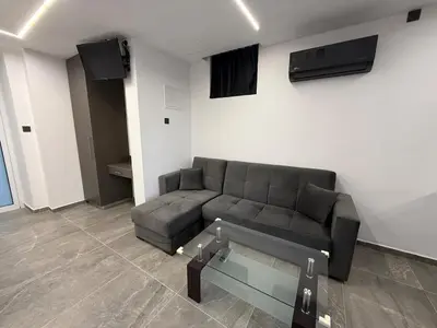 a living room with a couch and a glass table at Onar Exclusive Studio Suite in Voroklini