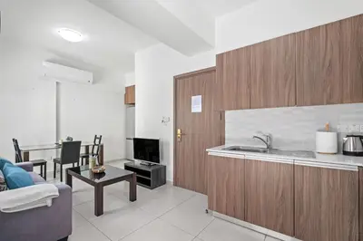 a kitchen and living room with a sink and a couch at Downtown 1 Bedroom City Apartment in Larnaka
