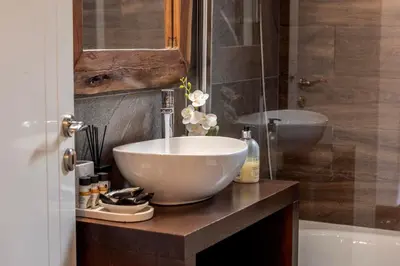 a bathroom with a bowl sink and a tub at Maison du Mont in Kalopanayiotis