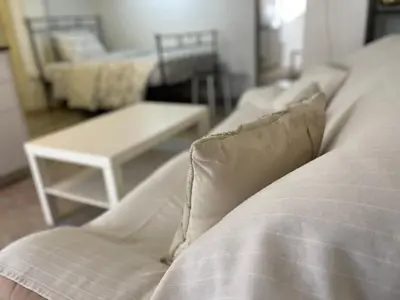 a living room with a couch and a table at Archangelos Studio in Strovolos
