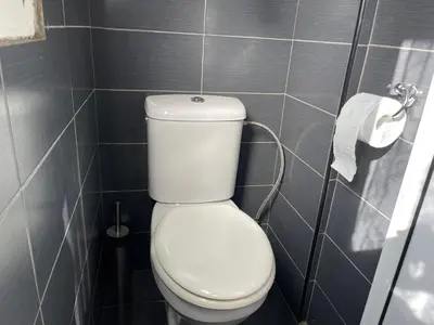 a bathroom with a toilet and a roll of toilet paper at Archangelos Studio in Strovolos