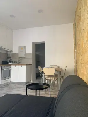 a living room with a table and a kitchen at Central Nicosia 1BR House in the Walled City in Nicosia