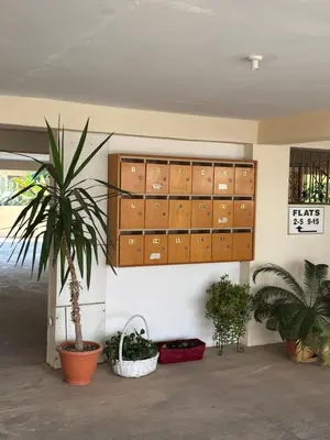 a room with potted plants and wooden cabinets at Kapparis Beach Escape in Paralimni