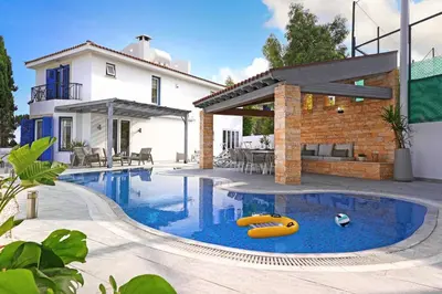 a swimming pool in a backyard with a house at Villa Amy - 100m from Nisia Loumbardi Beach in Protaras