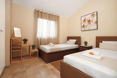 a bedroom with two beds and a window at Villa Amy - 100m from Nisia Loumbardi Beach in Protaras