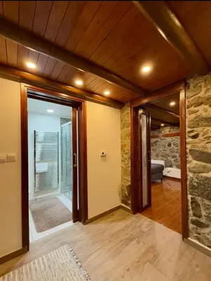 a room with a door and a stone wall at To Petrino 5 -Apartment- Nature, Comfort & Tradition Under One Roof in Kalopanayiotis