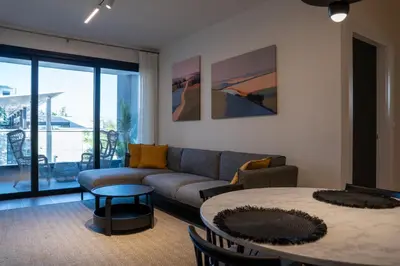 a living room with a couch and a table at Luxe One Residence in Aglantzia