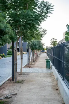 a sidewalk with trees on the side of a street at Luxe One Residence in Aglantzia