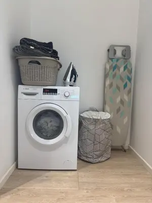 a laundry room with a washing machine and a bag at The Qube Residence 2 Bedroom Premium Apartment in Limassol