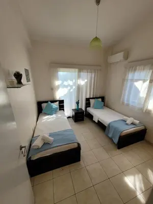 a bedroom with two beds and a window at Ayia Napa Marina Luxury Villas - Sapphire in Ayia Napa