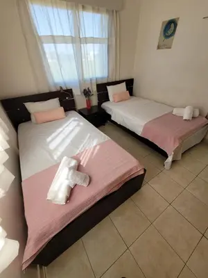 two beds sitting next to each other in a room at Ayia Napa Marina Luxury Villas - Sapphire in Ayia Napa