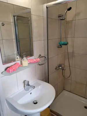 a bathroom with a sink and a shower with a mirror at Ayia Napa Marina Luxury Villas - Sapphire in Ayia Napa
