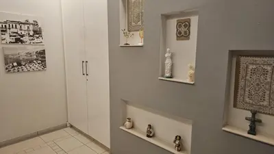 a hallway with a cross on the wall and a cross on a shelf at STAY Armonia Central Suite in Nicosia