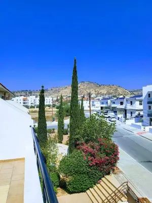 a balcony with trees and flowers on a city street at Sea View Valley Retreat in Voroklini