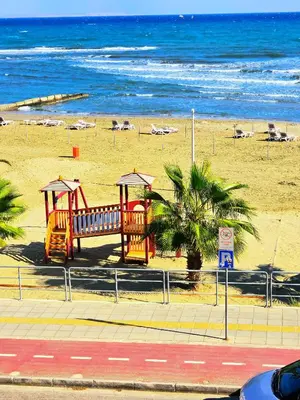 a playground on the beach near the ocean at Breathtaking Beachfront Apartment in Makenzy in Larnaka