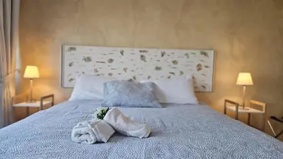 a bedroom with a bed with towels and two lamps at STAY Fantasia Central Suite in Nicosia