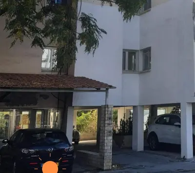 a black car parked in front of a building at Amato Beach in Limassol