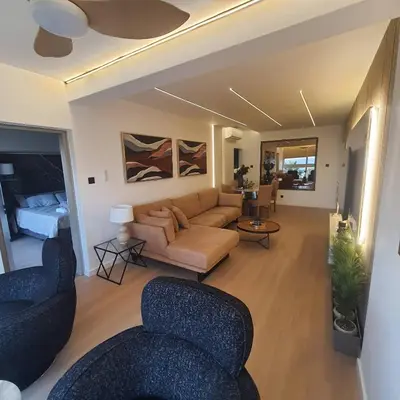 a living room with a couch and two chairs at Amato Beach in Limassol