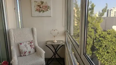 a chair with a pillow sitting next to a window at STAY Vintage Central Suite in Nicosia