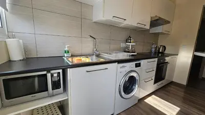 a kitchen with a sink and a washing machine at STAY Vintage Central Suite in Nicosia
