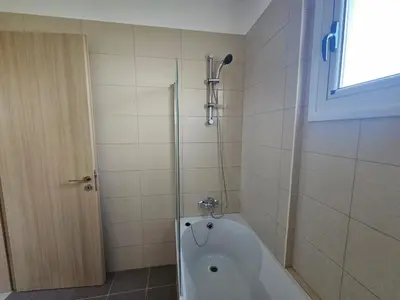 a bath tub in a bathroom with a shower at Horizon View 2 in Kiti