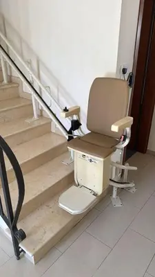 a chair sitting next to a set of stairs at Townbeach Villa with Private Pool in Voroklini