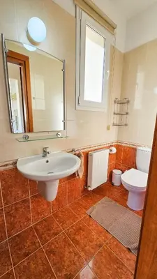 a bathroom with a sink and a toilet at Townbeach Villa with Private Pool in Voroklini