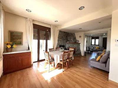 a kitchen and living room with a table and chairs at Kyperounta Heights - Breathtaking View in Kyperounda