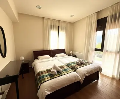 a bedroom with a large bed with towels on it at Kyperounta Heights - Breathtaking View in Kyperounda