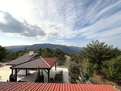 a view of a roof of a building with mountains in the background at Kyperounta Heights - Breathtaking View in Kyperounda