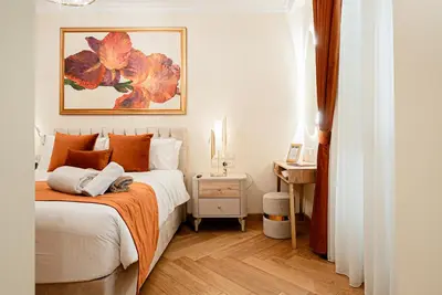 a bedroom with a bed with an orange blanket at Averde Residence in Larnaka