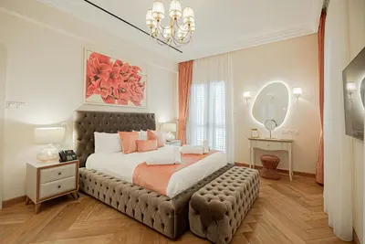 a bedroom with a large bed and a large mirror at Averde Residence in Larnaka
